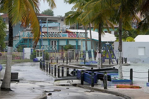 Boats lie capsized in a flooded street
